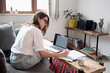 © ZHPH Production/Stocksy - Young woman study at home