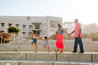 © Erin Brant/Stocksy - Happy family marching through amphitheater