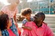 © Erin Brant/Stocksy - Dad smiling at sweet daughters outdoors