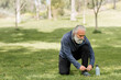 © McKinsey Jordan/Stocksy - Senior Man Ties His Shoe While at the Park