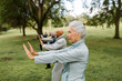 © McKinsey Jordan/Stocksy - Seniors Look Serious During Workout in the Park