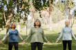 © McKinsey Jordan/Stocksy - Senior Women Practice Yoga in the Park