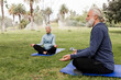 © McKinsey Jordan/Stocksy - Senior Man and Woman Meditate Together in the Park