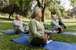 © McKinsey Jordan/Stocksy - Diverse Group of Seniors Meditate in the Park