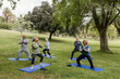 © McKinsey Jordan/Stocksy - Seniors in a Circle Practice Yoga in the Park