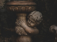 Closeup Of A Cherubim Sculpture Holding A Birdbath