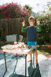 © Erin Brant/Stocksy - Boy with hands in air decorating eggs