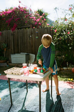 Barefoot Boy Painting Easter Eggs