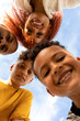 © Valentina Barreto/Stocksy - Low angle selfie of smiling black family outdoor
