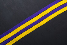 Yellow And Purple Shoelaces, Lakers Flag, On Black Wooden Background, Leaving Space For Advertising Text