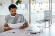 © BONNINSTUDIO/Stocksy - Serious man working with documents at workplace