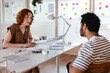 © BONNINSTUDIO/Stocksy - Colleague discussing business results in office