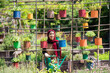 © Studio Marmellata/Stocksy - Muslim woman watering potted plants in summer garden