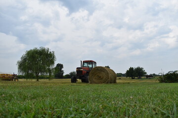 Wall Mural - Tractor and Hay Bale in a Field