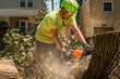 © Gabriel (Gabi) Bucataru/Stocksy - Tree service worker cutting a log
