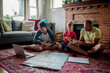 © Erin Brant/Stocksy - Brothers use map to plan trip