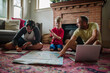 © Erin Brant/Stocksy - Father points to map on floor