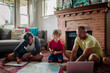© Erin Brant/Stocksy - Happy father and sons plan family trip