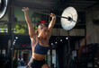 © Jovo Jovanovic/Stocksy - Muscular female athlete lifting heavy weights at gym