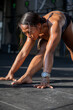 © Jovo Jovanovic/Stocksy - Athlete stretching on a floor of the gym looking strong