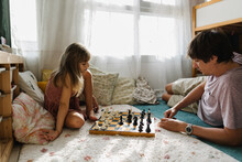 A Girl Playing Chess With Dad
