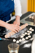 © Studio Marmellata/Stocksy - Anonymous woman rolling raw dough at table in kitchen
