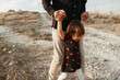 © Irina Polonina/Stocksy - A father walking with a small daughter outdoor.