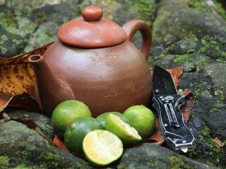 Wall Mural - a traditional teapot and cup that is unique from Indonesia because it is made of clay, to brew a healthy & fresh lemon drink.