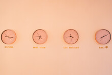 Clocks With Different Time Hanging On Wall