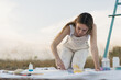 © Javier Pardina/Stocksy - Woman artist mixing colors at nature