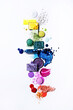 © Magdalena M/Stocksy - Colourful cosmetics flat lay rainbow with powder, liquid and glitter