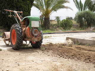 Poster - Walk-behind tractor in a field surrounded by trees