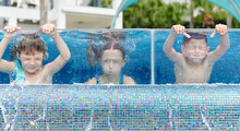 Children Holding Their Breath Underwater In A Pool
