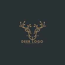 An Abstract Logo Depicting A Deer  In Brown Color On A Dark Background. Its Antler Looks Like Tree Branch Complete With Leaves On It.