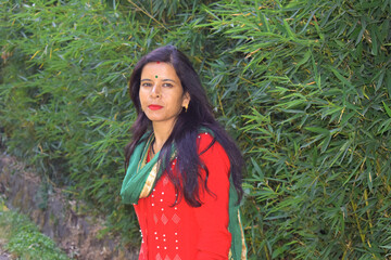 Beautiful, young and simple Indian woman with green grass background