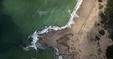 An Aerial Top View Of Waves On A Seashore In Punta Del Diablo, Uruguay