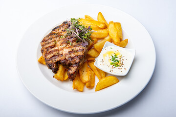 Grilled pork neck with chips and homemade mayonnaise