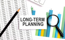 LONG-TERM PLANNING Text On White Card On The Chart Background