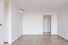 Empty Apartment With White Walls And Air Conditioner At Daytime