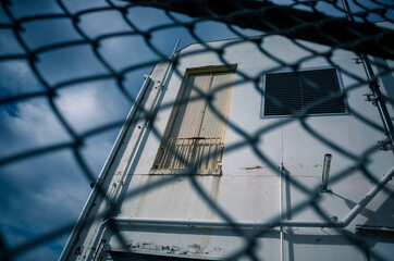 Wall Mural - old building behind a fence