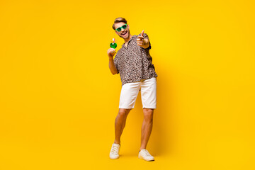 Poster - Full length photo of attractive cute gentleman dressed print shirt glasses drinking cocktail pointing you isolated yellow color background