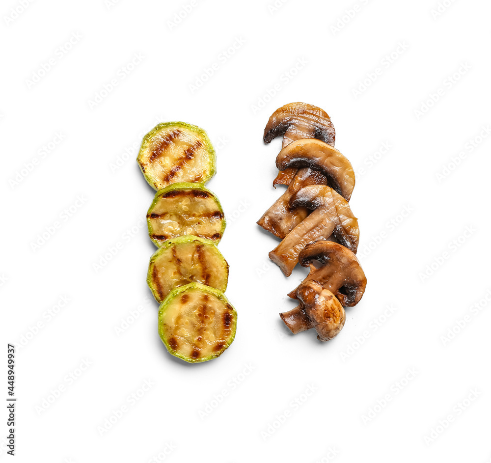 Tasty grilled squash and mushrooms on white background