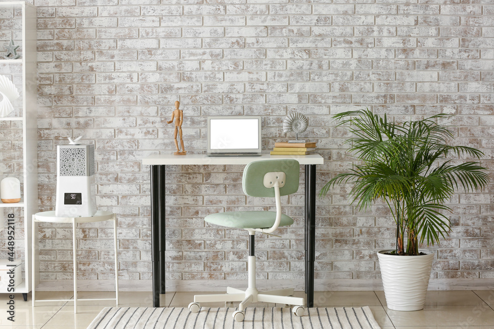 Interior of room with workplace and modern humidifier