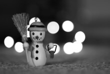 Small Decorative Snowman On A Bokeh Blurred Background