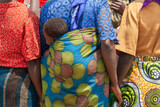 Fototapeta  - african woman colorful clothings carrying baby