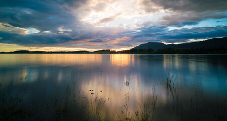 Poster - Sunset on the lake with the reflection of the sunset sky in the water