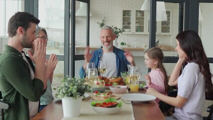 Wall Mural - Happy multi-generation family smiling while having dinner together