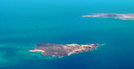 Wall Mural - Photo taken by a plane of the Lobos Island, part of the island of Lanzarote and the Atlantic Ocean. Canary islands, Spain.