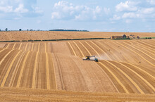 Crop Havesting With Combine On A Dry Sunny Day