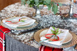 Silver tablecloth on the table. The plate is decorated with flowers